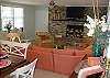 This area is a combination living space- family room with large flat screen TV, lots of seating, small step up to dining room area and leads to the kitchen as well.
