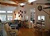 This view is of the living room area of the Great Room showing the seating area and looking towards the third bedroom and library area.