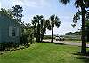 This is the side yard looking towards the front and the marsh. Parking for up to 3 cars and or a small boat on a trailer.