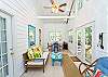 The sun room showing the french doors to the back yard and patio and the electric fireplace.