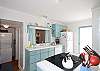 Another view of the very cute kitchen; check out the aqua cabinetry; so fun and beachy!