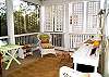 The back porch is screened and located right off the kitchen. Tall ceilings, lots of great seating. The porch is very relaxing and quiet.
