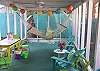 Views of the screened porch on rear of cottage.  Fun, bright and colorful!