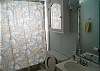 The bathroom is a full bath with a shower/ tub combination