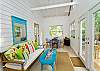 Our back room features windows, natural sunlight, the back deck and ideal place to relax. The south window features a partial marsh view. We also have an electric fireplace to keep you warm and cozy in the winter.