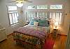 The first floor bedroom features a queen bed and full master bathroom. Hardwood floors, TV and windwos everywhere.