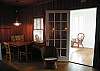 The sun room leads right into the living room/ dining room/ kitchen.  The original pine paneling and heart of pine flooring is throughout the entire home.