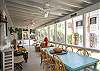 The screened porch has lots of seating as well as a large farm style table and chairs to enjoy meals or playing games.