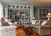 The book shelves are filled with hundreds of books, games and puzzles for all ages and large TV/ DVD. The entire home features hardwood floors.