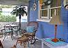Lovely comfy screened porch.  Sit and relax and watch the people go by!