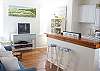 The middle room of the Mess Hall is the combination galley kitchen, family room,dining room, gathering space.  The tv/ dvd is front and center but the room is filled with vintage treasures. We love how this room turned out!