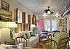 The Living room is open with lots of seating and an entire wall of books to enjoy! Vintage details in every corner of this room!