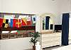 The masterbedroom overlooks the living room. The nautical flags spell SHORE LEAVE.