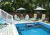 The pool area features lots of seating and even a couple of umbrellas to enjoy.