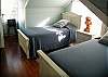 The 2nd floor includes 2 twin beds, a full bathroom, small TV and kids play area.