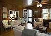 Original paneling makes quaint and comfortable. Large television, sofa and two relaxing chairs.