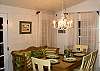The dining room area also leads out to the screened porch. The table seats 6 and the kitchen bar counter seats another 3.
