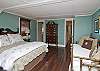 More details of the 2nd floor bedroom. We love the wicker sofa, brass twin bed and beautiful dark wood floors