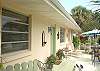 The side patio leads to the front door. There are wonderful views of Sunset and the back river from this patio.