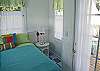 Bedroom 3 with the entrance to the outdoor private deck and outside shower