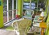 Screened porch faces Jones Ave. Front yard is surrounded by a picket fence