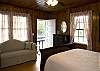 Comfortable Pine Cone Hill linens and pillows provide restful sleep!Large second bedroom with camel back sofa and queen sleigh bed. Screen door opening to porch.