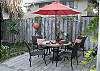 The back yard and garden features two seperate seating areas with large unbrellas. The yard is not fenced in, however there's plenty of area to play and relax.