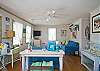 Large, open, bright family room with denim beach-friendly furniture &amp; flatscreen TV.