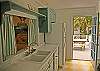Kitchen looking out to the back deck with grill