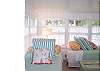These twin beds are brimming with cheery linens and lots of pillows. Once a porch,this room offers a sunny spot to sleep or read. There is a curtain to close when it is time to set in for the night!