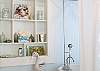 The Master Bathroom is painted pale blue, home to the vintage claw-foot bathtub with shower and a wall full of another of Mary Kay Andrews collection of seashells and other beachy treats.