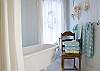 The large Master Bathroom off the master bedroom features a claw -footvintage bath tub, subway tile and lush bath linens.