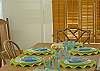 Dining area seats eight at heart-pine harvest table, adjacent to kitchen.  There is an antique wicker high-chair for our youngest guests.