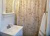 The master bathroom has a bath/ shower combination.
