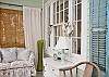 Another view of the shell wreaths, blue shutters and slipcovered sofa loveseat.