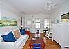 This large light filled room includes a sofa, chairs, dining room table and Cable tv.  Full of wonderful nautical details