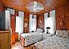 This bedroom has 2 twin beds. Also equipped with cable TV.