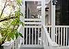 Door and staircase outside from the enclosed porch off of ktichen.