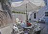 Our fully enclosed backyard/ courtyard features the outdoor seating and some terrific local outdoor art ( note the fish made from a surfboard!) We have a gas grill and a beach cart for you to use.