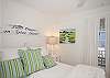 King bedroom; crisp cottage white featuring local art and lots of cottage charm! Flatscreen TV.