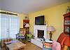 The living room is on the first floor and features a fireplace and a flat screen large tv over the fireplace.