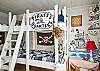 Downstairs bedroom #2.  Bunk beds on bottom; top of beds are for play; not a sleeping area.  Perfect pirate decor!