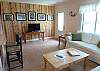 Our living room has a sofa, love seat, Cable TV, and wonderful photography from the owners!  Great space!