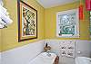 Main bathroom; bright colors, vintage tub and gorgeous details!