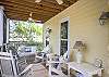 The home has 3 screened porches- two in the front and one in the back. These is the front porch. Lots of great seating including rocking chairs.