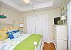 Another view of the light, bright and airy bedroom upstairs with queen bed and a private balcony. Note the flat-screen TV in the far corner.