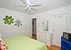 King bedroom. Splashes of color and fun wall hangings make this room a favorite!