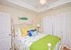 Second bedroom upstairs.  Another light, bright and airy bedroom with queen bed and a private balcony. Note the flat-screen TV in the far corner.