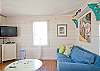Large, open, bright family room with denim beach-friendly furniture &amp; flatscreen TV.