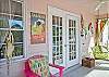 Bright, colorful screened porch awaits you at Barefoot Children!